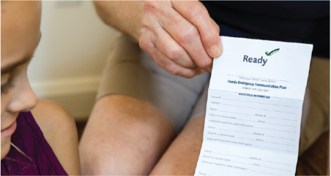 woman showing a girl the Family Emergency Communication Plan